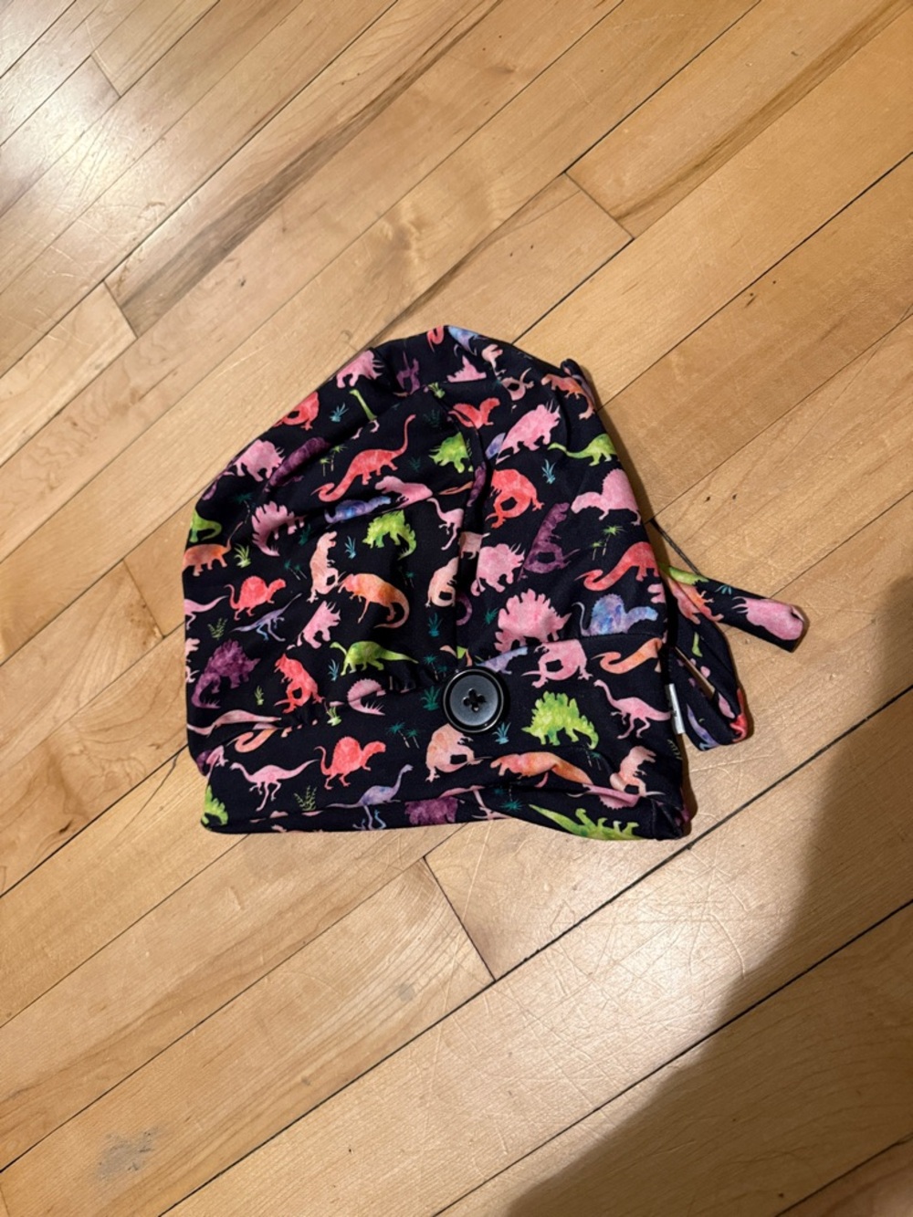 Dinosaur print scrub cap with buttons for mask